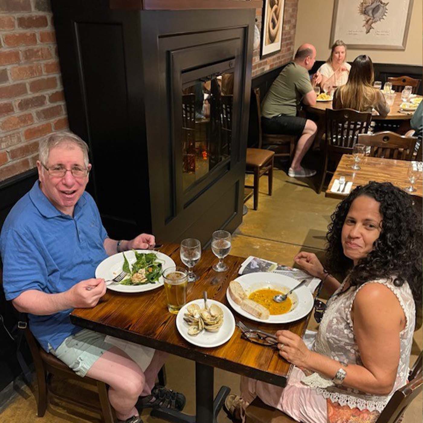 lifesharing family having dinner at a restaurant together