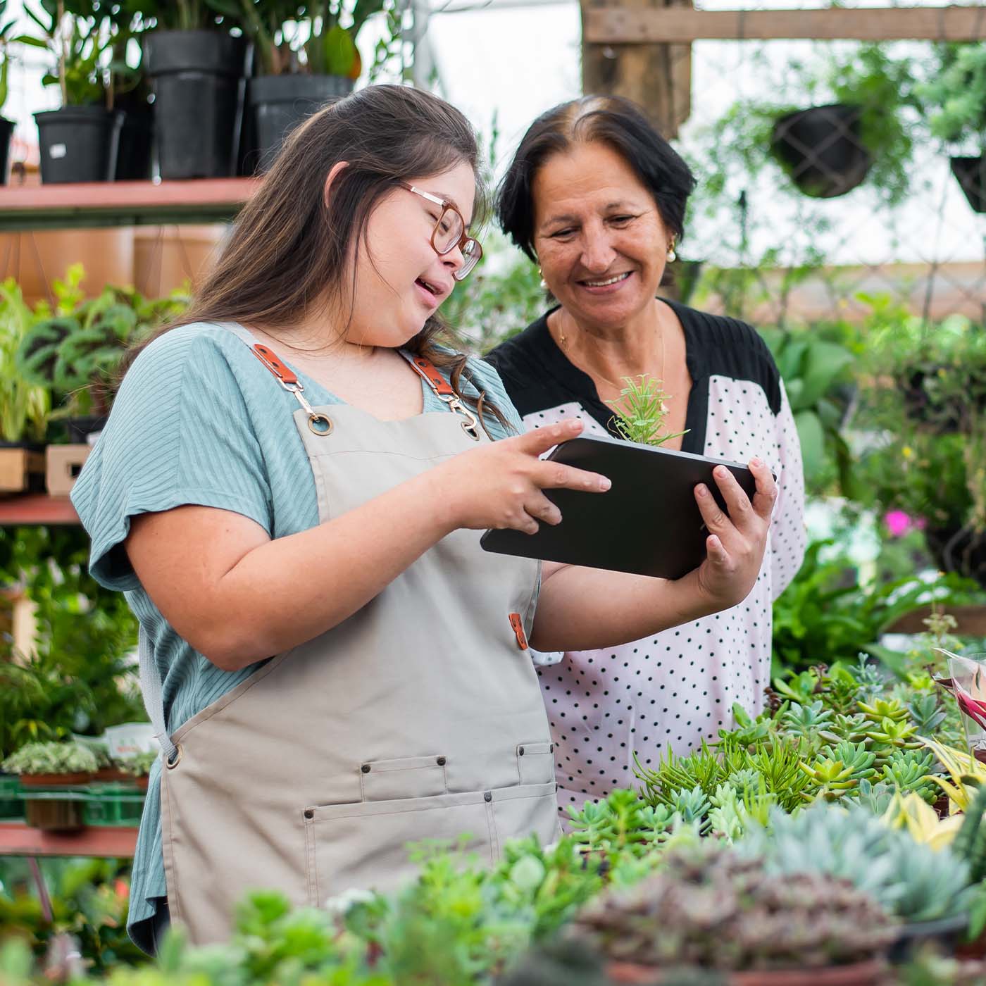 young lady with down syndrome working at a greenhouse