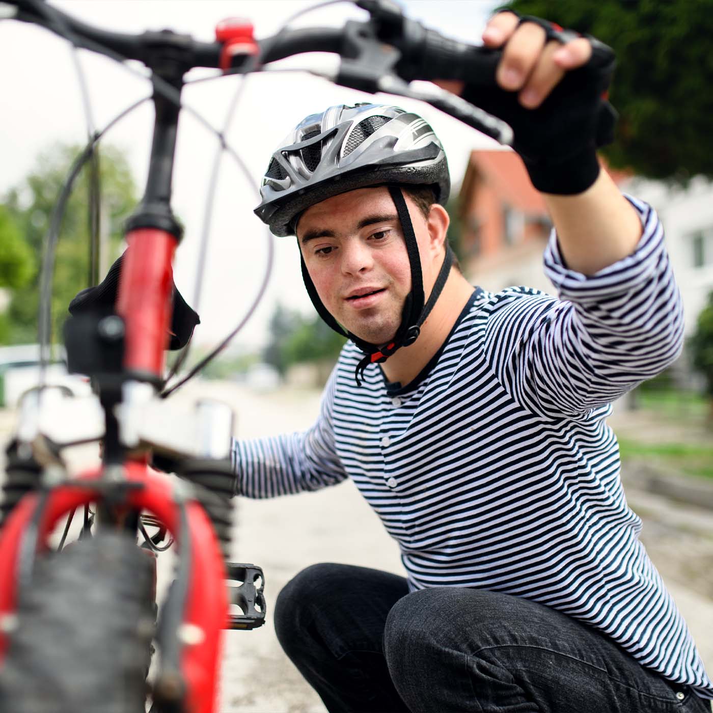 young man with down syndrome learning how to ride a bike