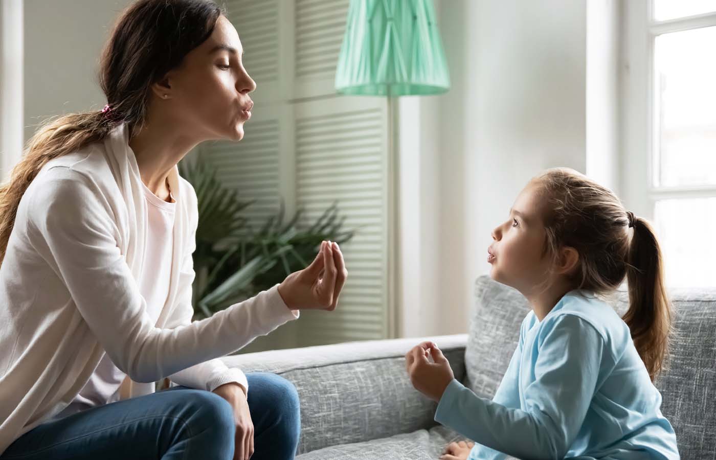 behavioral health technician teaching a young girl deep breathing as a coping skill