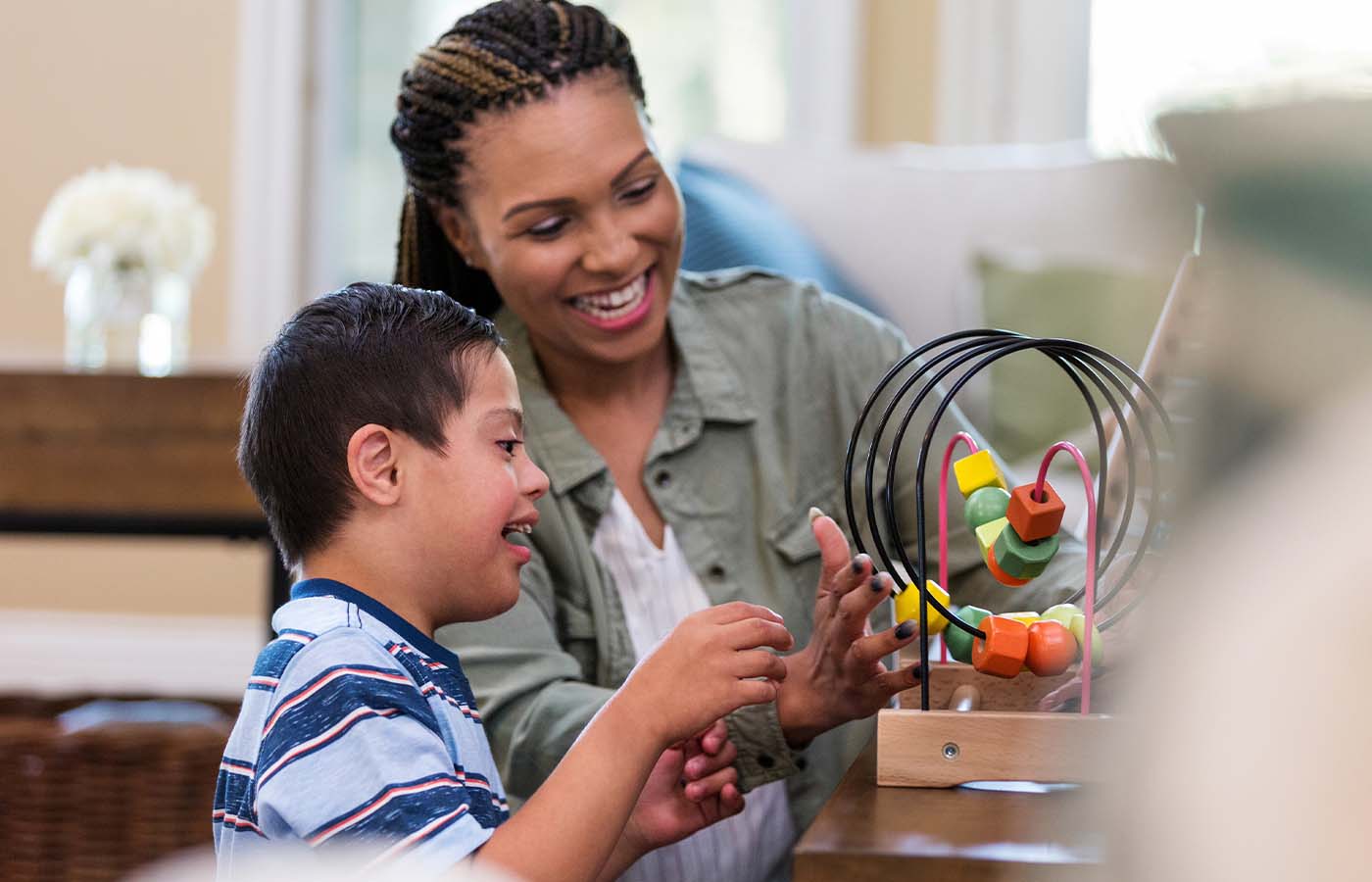 boy playing with toys with an adult friend