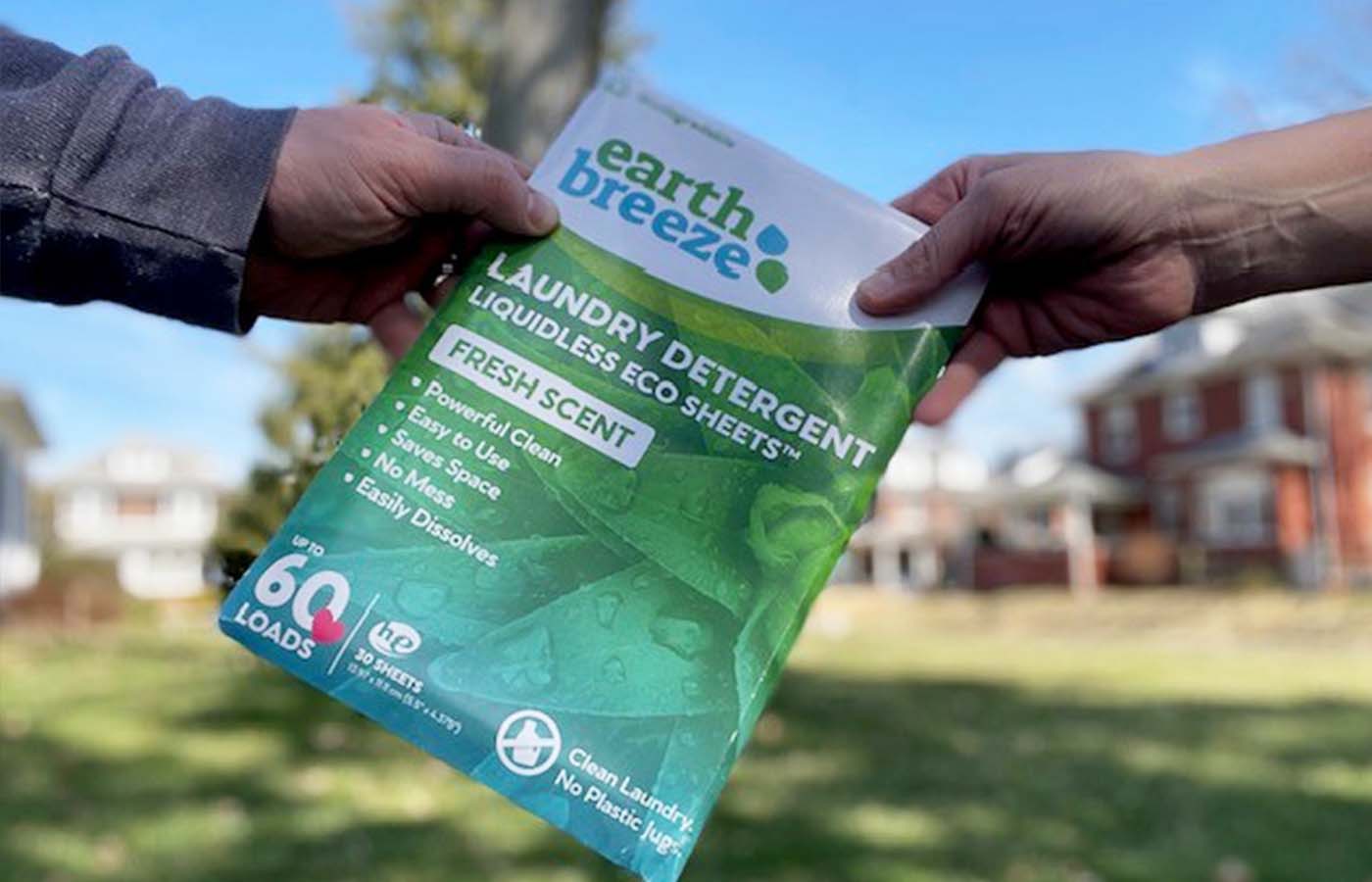 people passing a bag of earth breeze laundry detergent