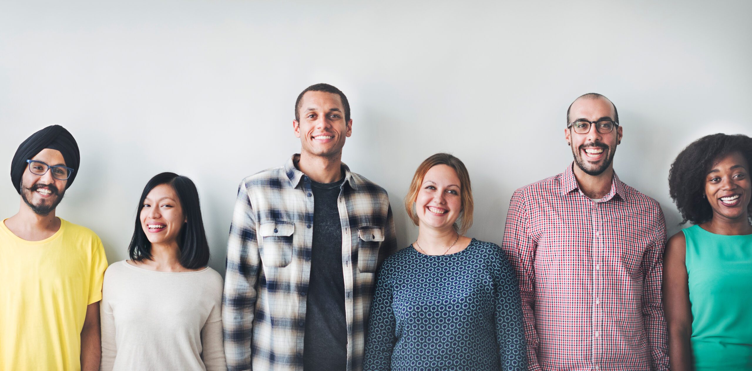 a group of people standing in a line and smiling